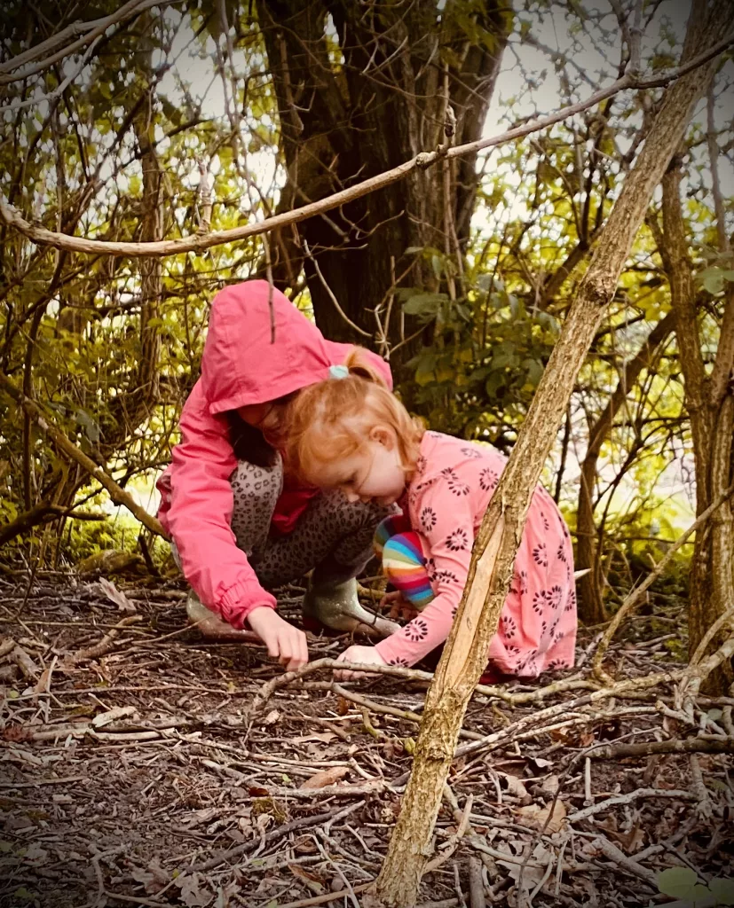 two children exploring nature in the woods