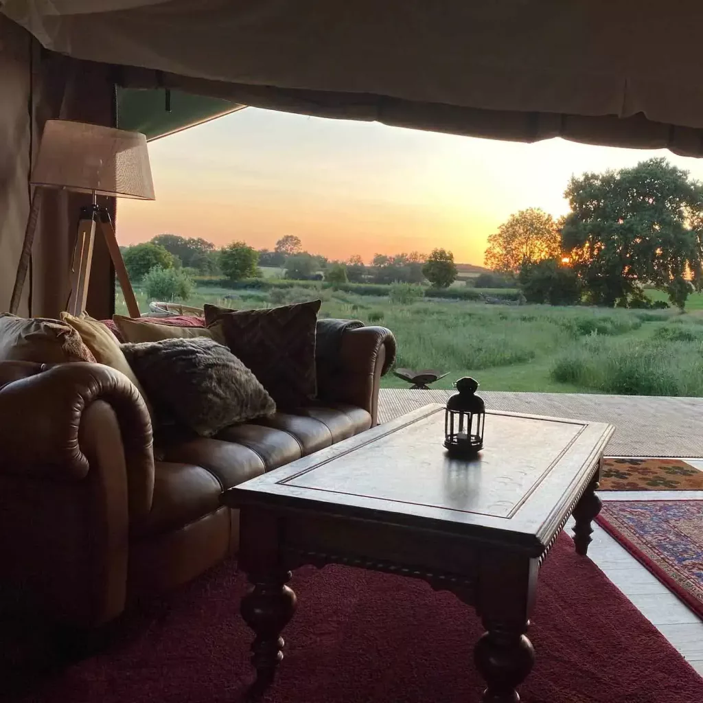 sunset view across fields from a safari tent